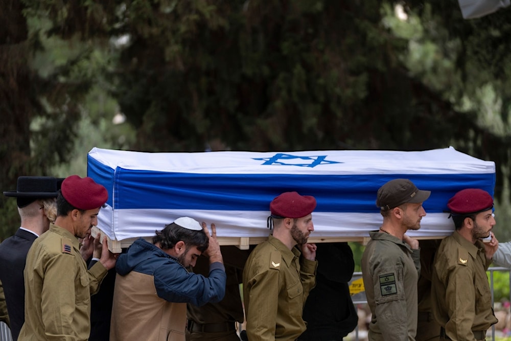 Israeli occupation soldiers carry the flag-draped casket during the funeral of another occupation soldier, on Tuesday, May 7, 2024. (AP)
