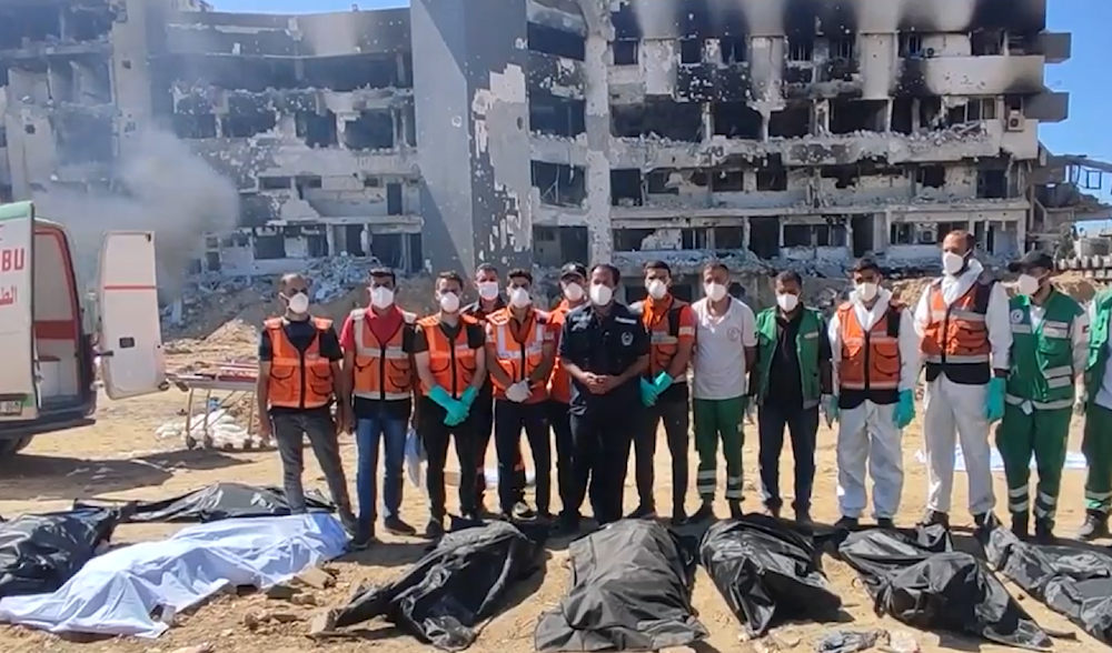 Gazan rescue teams after discovering the third mass grave in Al-Shifa Hospital on May 8, 2024 (Screengrab)