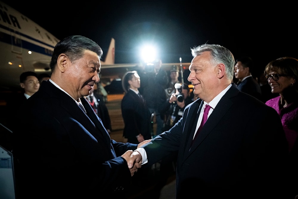Chinese President Xi Jinping, left, shakes hands with Hungarian Prime Minister Viktor Orban as he arrives for a state visit at the Liszt Ferenc International Airport in Budapest, Hungary, Wednesday, May 8, 2024. (AP)