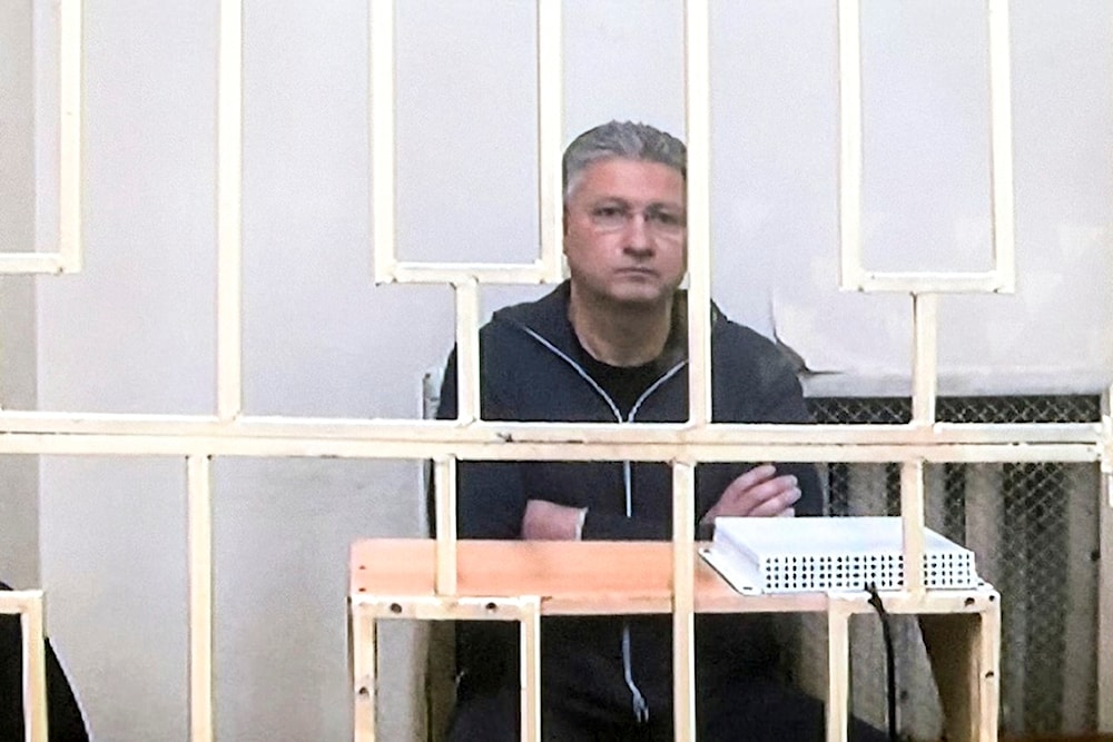 Russian Deputy Defense Minister Timur Ivanov sits behind bars in a video link provided by the Russian Federal Penitentiary Service at the Moscow City Court, in Moscow, Russia, on Wednesday, May 8, 2024 (AP)