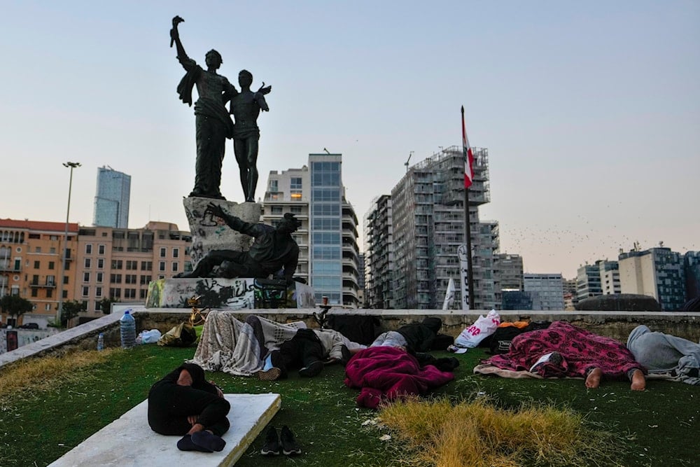 People sleep in Beirut's Martyrs' square after fleeing the Israeli airstrikes in Beirut's southern suburb, Lebanon, on September 30, 2024. (AP)