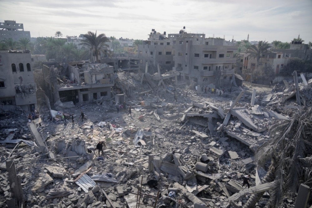 Palestinians look at destruction by the Israeli bombardment of the Gaza Strip in Deir al-Balah, occupied Palestine,Wednesday, November 22,2023. (AP)