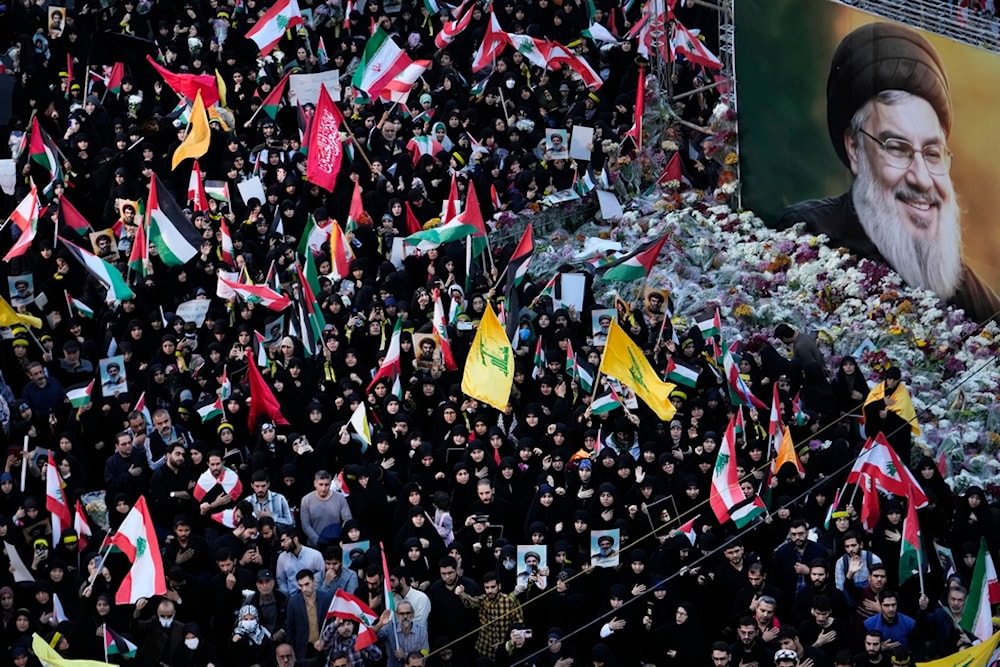 Mourners attend a rally commemorating slain Hezbollah leader Hassan Nasrallah, shown on a billboard, at Felestin (Palestine) Square in downtown Tehran, Iran, Monday, September 30, 2024 (AP)