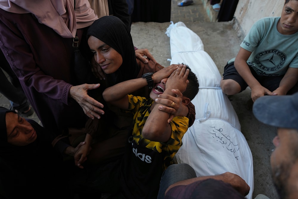 Mourners attend the funeral of Palestinians killed in the Israeli bombardment of the Gaza Strip outside the hospital morgue in Deir al-Balah on October 9, 2024. (AP)