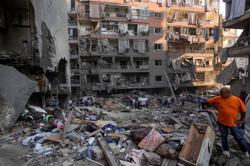 A resident gestures as rescue workers search for victims at the site of Thursday's Israeli airstrike in Beirut, Lebanon, Friday, October 11, 2024 (AP)