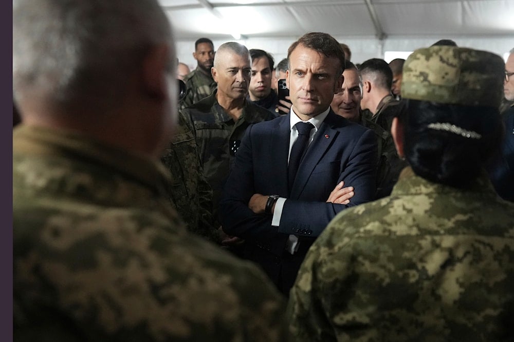 French President Emmanuel Macron speaks with Ukrainian soldiers in a military camp in eastern France, October 9, 2024. (AP)