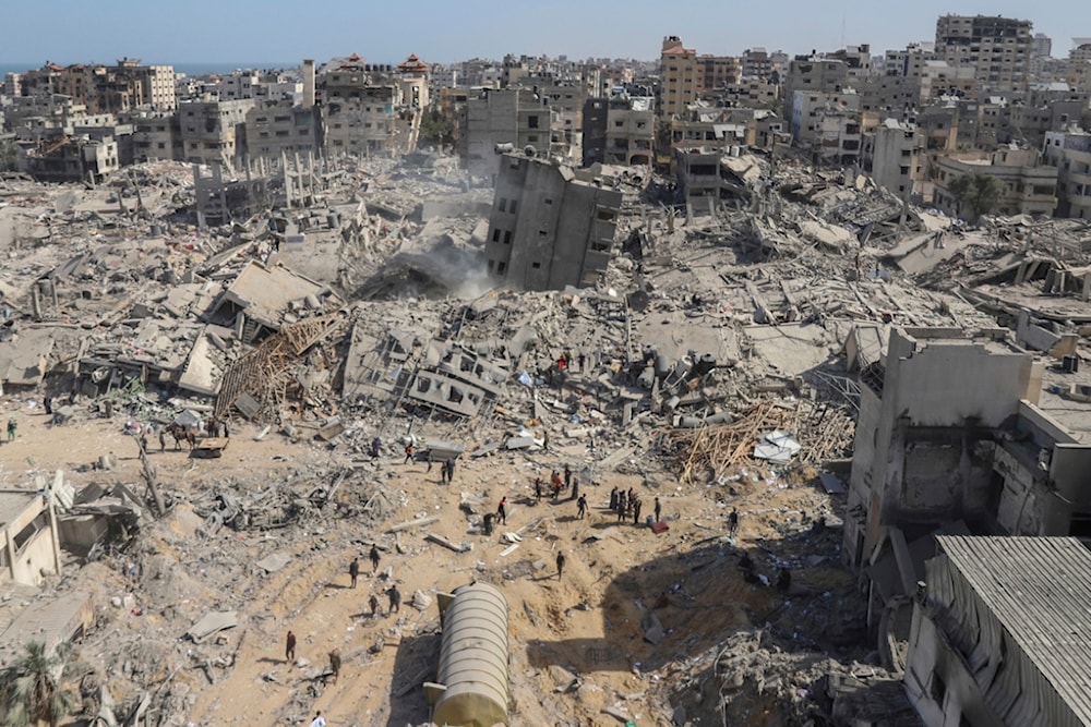 Palestinians walk through the destruction left by the Israeli air and ground offensive on the Gaza Strip near Shifa Hospital in Gaza City, Monday, April 1, 2024. (AP)