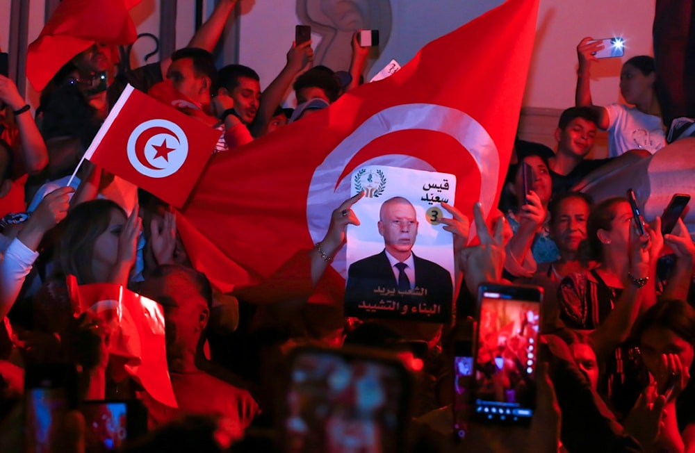 Supporters of Tunisian president and candidate for re-election Kais Saied celebrate after the announcement of the provisional results for the presidential elections, in the capital Tunis, Tunisia, Sunday, Oct. 6, 2024. (AP)