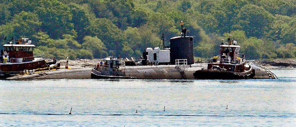 In this Friday, June 12, 2015 photo provided by the U.S. Navy, tugs assist as the former USS Miami nuclear-powered submarine is towed from the Portsmouth Nasal Shipyard in Kittery, Maine. (AP)