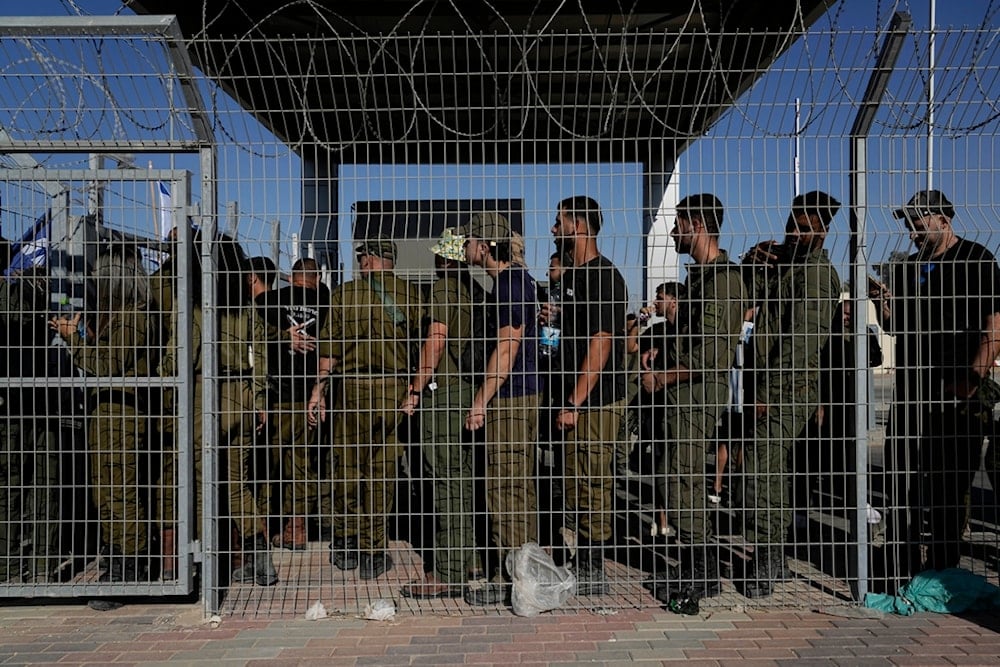 Israeli soldiers gather at the gate to the Sde Teiman de)tention camp in Gaza, occupied Palestine, July 29, 2024 (AP)