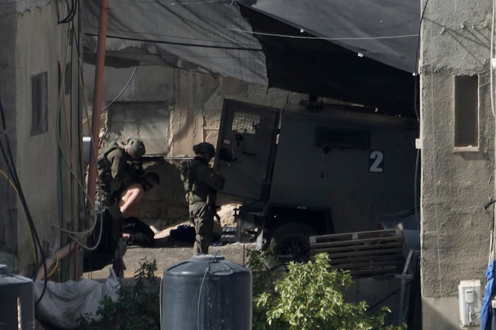 The Israeli army arrest a Palestinian man in the West Bank town of Qabatiya during a raid, on September 19, 2024. (AP)