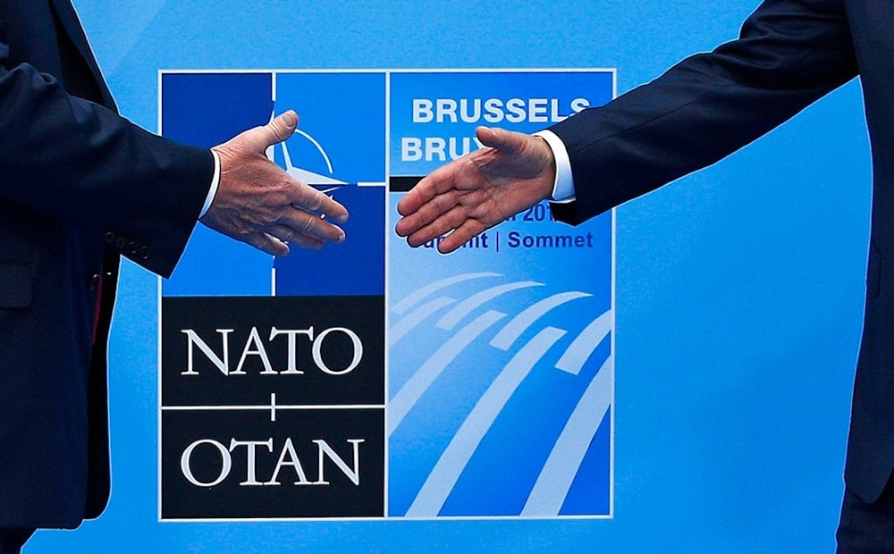 U.S. President Donald Trump, left, is greeted by NATO Secretary General Jens Stoltenberg before a summit of heads of state and government at NATO headquarters in Brussels on Wednesday, July 11, 2018 (AP)