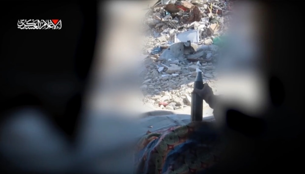 An al-Qassam Brigades fighter loads a mortar shell to be fired at the Israeli occupation forces in Jabalia, northern Gaza, occupied Palestine, on October 12, 2024 (al-Qassam Military Media)