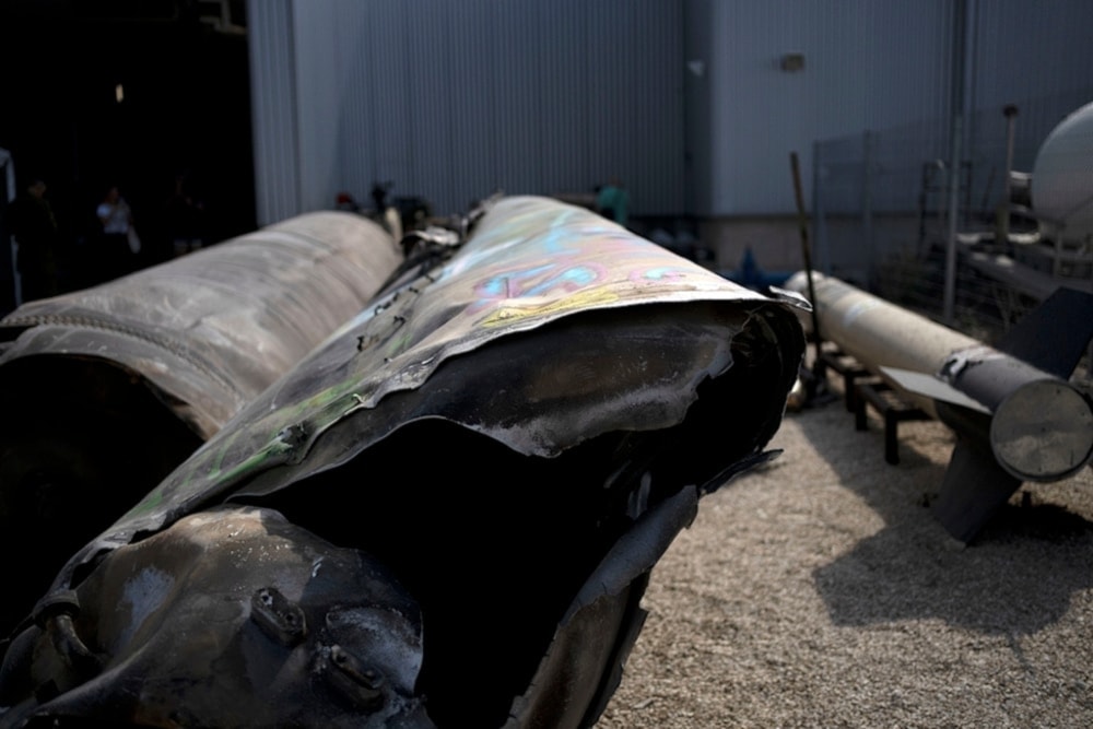 Iranian ballistic missile components that were fired at Israeli targets are displayed during a govermenet organized media tour on a base in southern occupied Palestine, Wednesday, October 9, 2024. (AP)