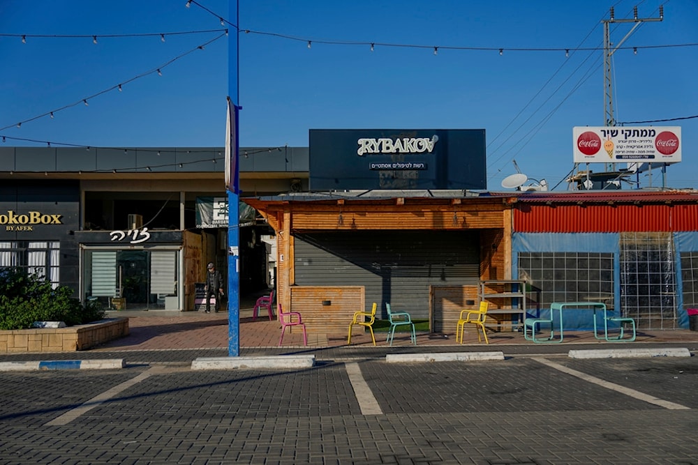 A man walks past closed business due to the war on Gaza, in 