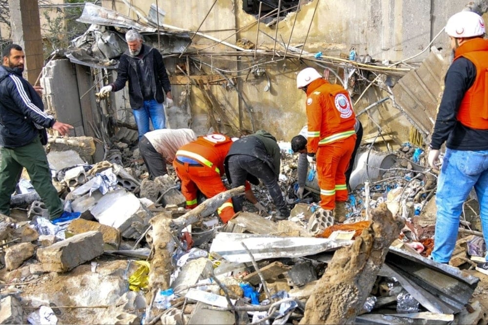 Medical workers inspect the site of the Israeli airstrike in Hebbariyeh in March. (AFP via Getty Images)