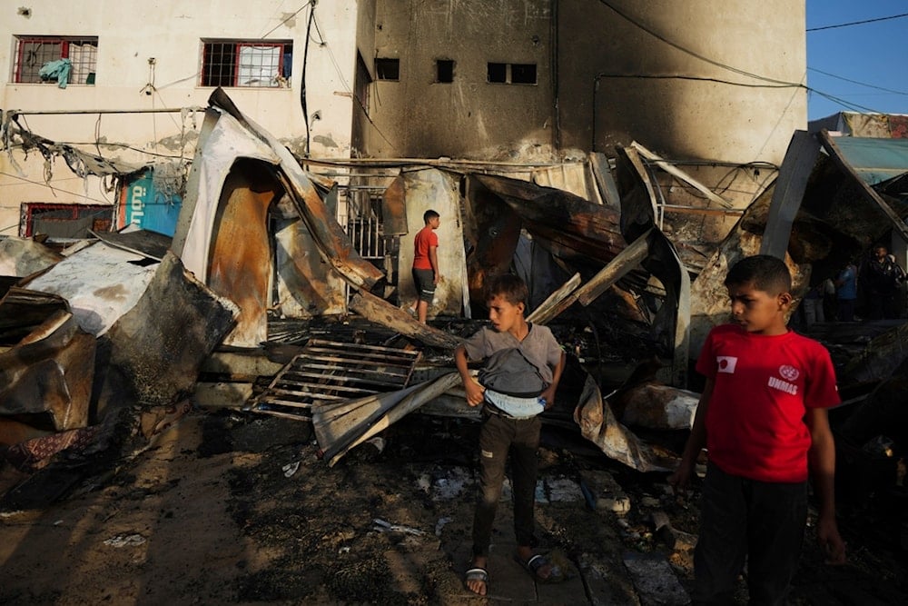 Palestinians look at the damage after an Israeli strike hit a tent area in the courtyard of al-Aqsa Martyrs Hospital in Deir al Balah, Gaza Strip, Monday, October 14, 2024 (AP)