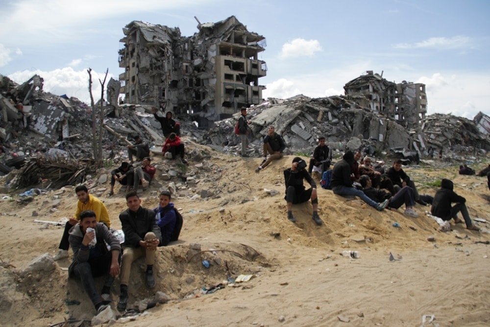  Palestinian children sit on the rubble of their Israeli-bombarded homes in Gaza City, Gaza Strip, occupied Palestine, March 9, 2024. (AP)