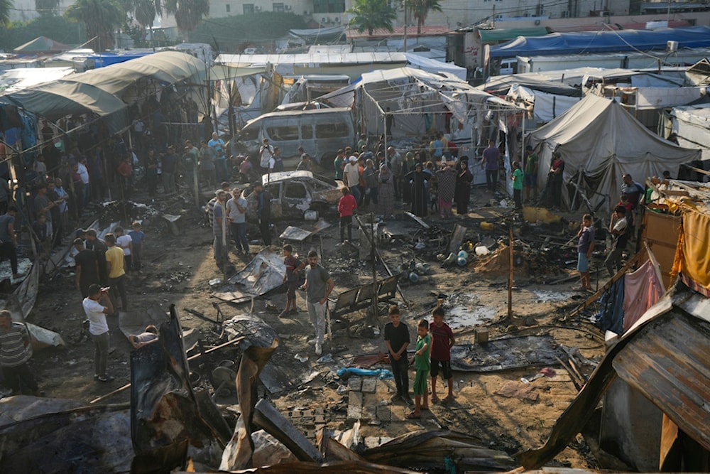 Palestinians look at the damage after an Israeli strike hit a tent area in the courtyard of Al Aqsa Martyrs hospital in Deir al Balah, Gaza Strip, Monday, Oct. 14, 2024. (AP)