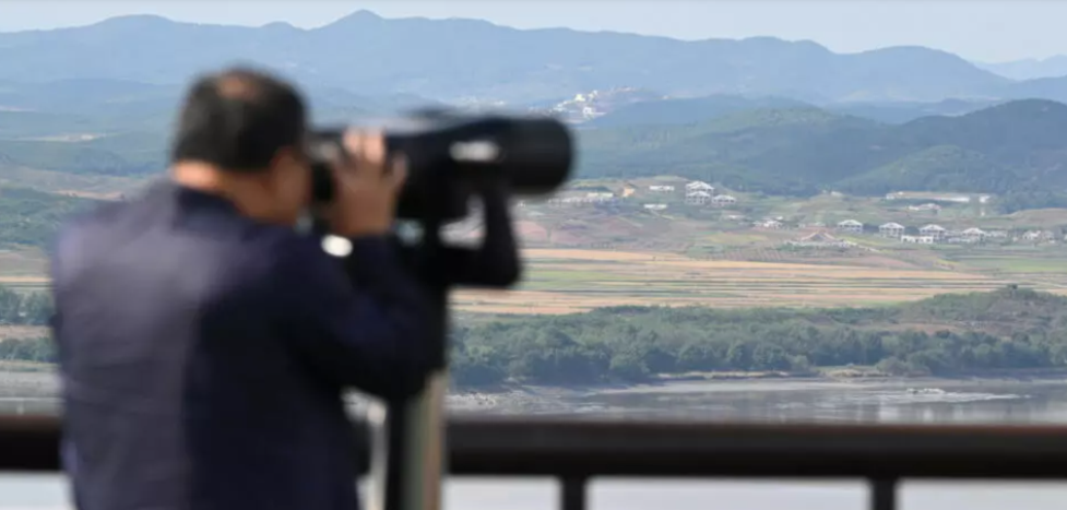 A man uses binoculars to look at the DPRK side of the Demilitarised Zone from South Korea's Odusan Unification Observatory in Paju. (AFP)