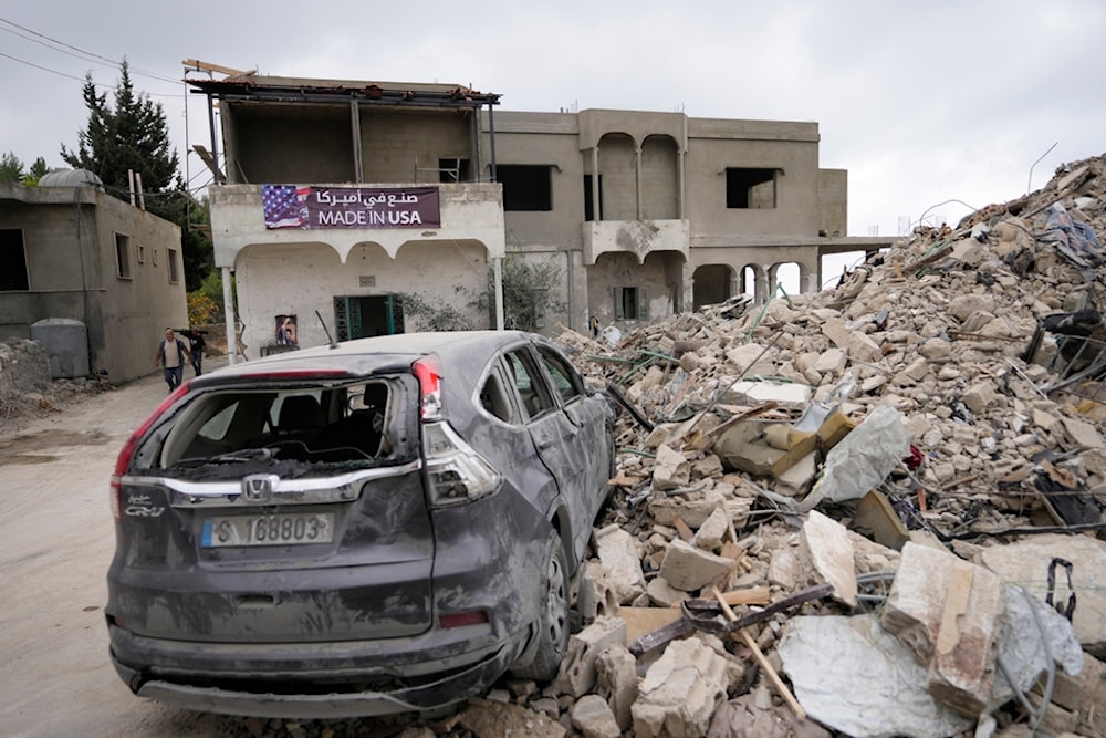 A car sits on the rubble of a building damaged in an Israeli airstrike, in Maisara near the northern coastal town of Byblos, Lebanon, Monday, Oct. 14, 2024. (AP)