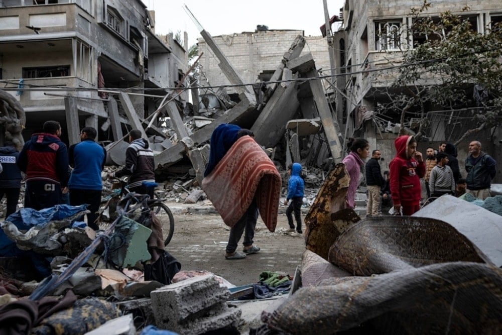  Palestinians inspect the damage of resdiential buildings after an Israeli occupation airstrike in Rafah, southern Gaza Strip, occupied Palestine, Sunday, March 24,2024. (AP)