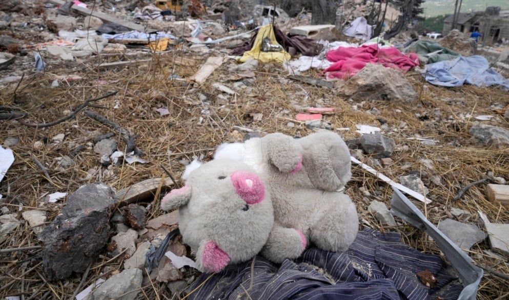 A teddy bear lies on the rubble of a destroyed building at the site of Monday's Israeli occupation airstrike in Aito village, north Lebanon, Tuesday, Oct. 15, 2024. (AP)