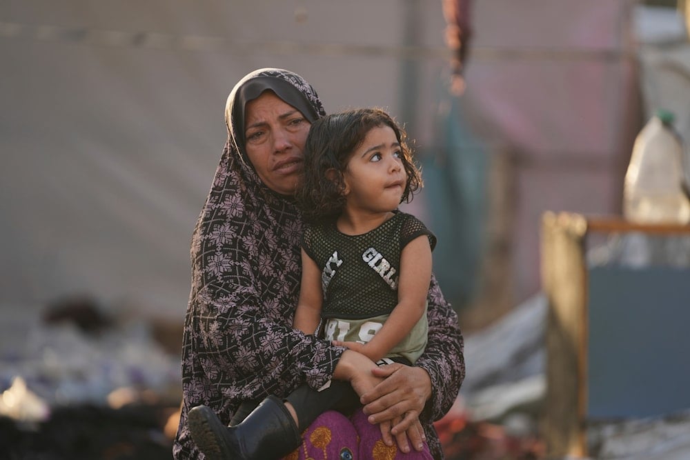 Palestinians look at the damage after an Israeli strike hit a tent area in the courtyard of Al Aqsa Martyrs hospital in Deir al Balah, Gaza Strip, Monday, Oct. 14, 2024. 