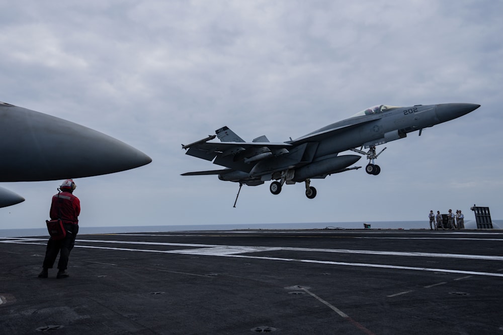 A fighter jet lands on the US aircraft carrier Dwight D. Eisenhower, also known as the 'Ike', on the south Red Sea, February 12, 2024. (AP)