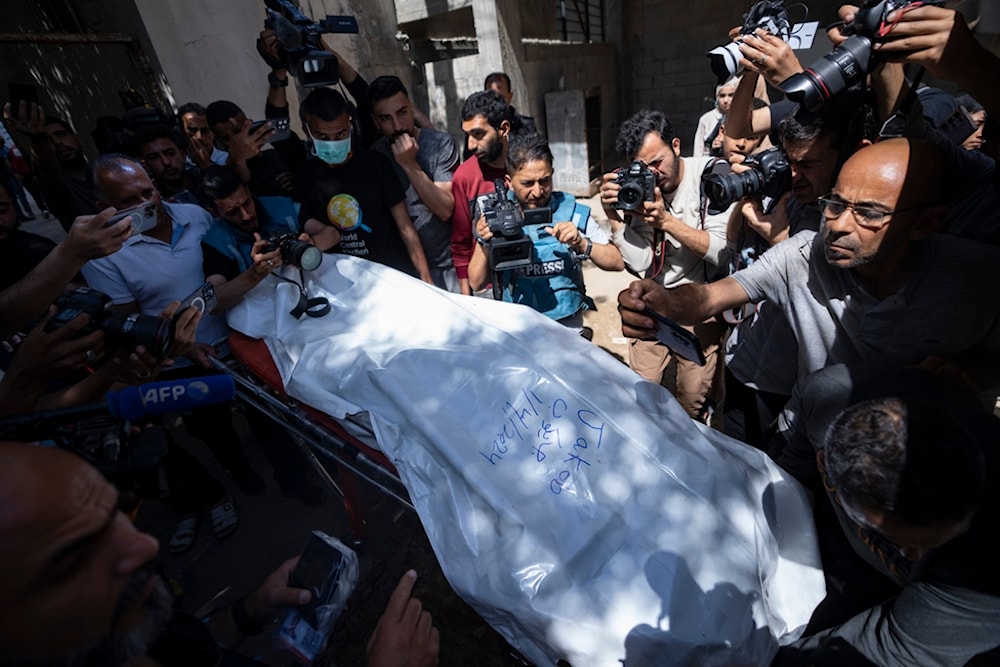 Members of the World Central Kitchen aid group, transports the body of one of the six foreign aid workers who were killed in an Israeli strike, at a hospital morgue in Rafah, Wednesday, April 3, 2024 (AP)