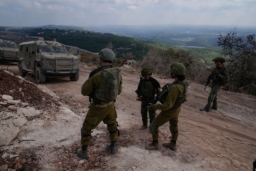 Israeli soldiers are seen during a ground operation in southern Lebanon, near the border with occupied Palestine, on October 13, 2024. (AP)