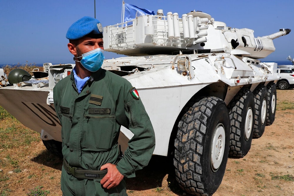 An Italian UN peacekeeper soldier stands guard at a road that links to a United Nations Interim Force In Lebanon (UNIFIL) in Naqoura, Lebanon, Tuesday, May 4, 2021 (AP)