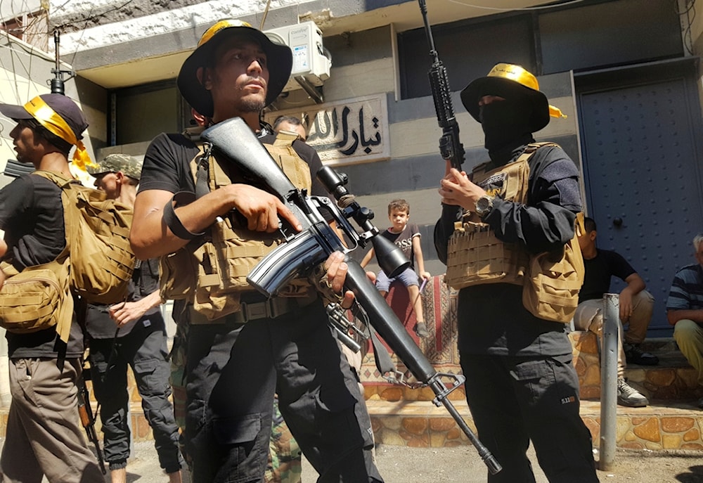 Palestinian Fatah fighters from Al-Aqsa Martyrs' Brigades, stand guard during the funeral procession of Khalil al-Maqdah, Aug. 21, 2024. (AP)