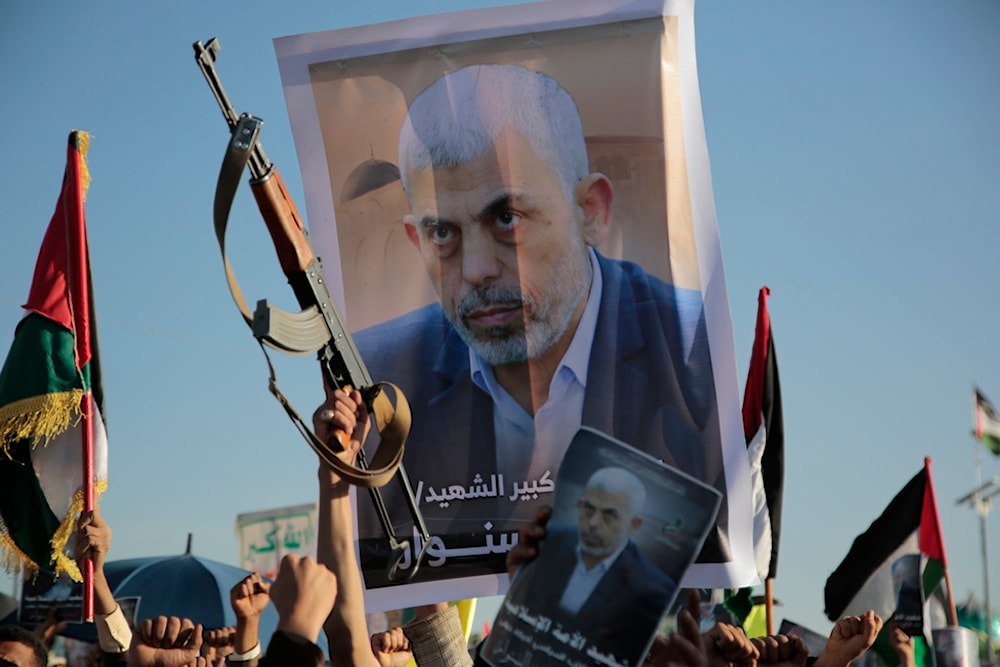 Yemenis raise a poster of martyred Hamas leader Yahya Sinwar during an anti-Israeli rally in Sanaa, Yemen, Friday, October 18, 2024 (AP)