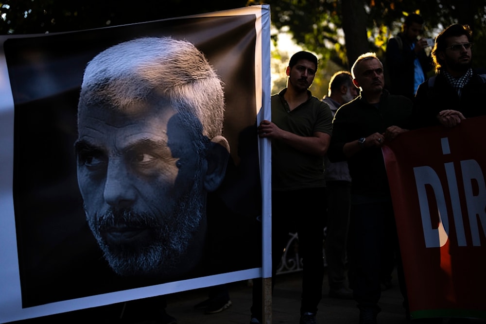 A man holds a banner with a photograph of martyred Hamas leader Yahya Sinwar during a pro-Palestinian protest in Istanbul, Turkey, Saturday, October 19, 2024 (AP)