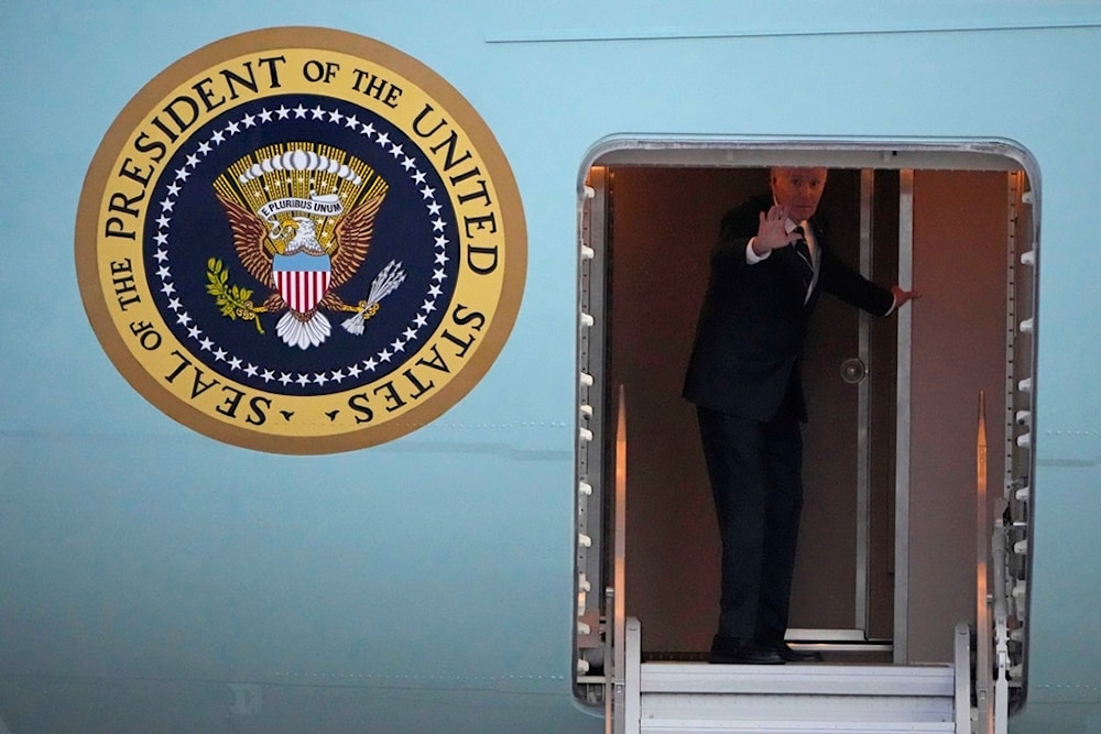 U.S. President Joe Biden waves as he boards Air Force One for departure at Brandenburg Airport in Schoenefeld near Berlin, Germany, Friday, Oct. 18, 2024. (AP)