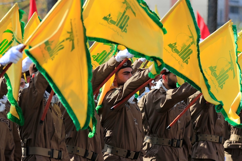 Hezbollah fighters raise their group flags during the funeral a Hezbollah commander and another fighter who were assassinated by an Israeli drone strike, in Chehabiyeh village, south Lebanon, April 17, 2024. (AP)