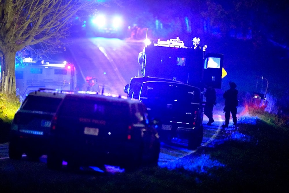 Law enforcement officers stand near armored and tactical vehicles in Bowdoin, Maine, following a mass shooting, Oct. 26, 2023. (AP)