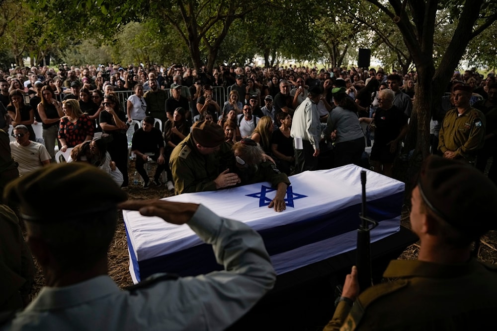 People cry over the flagged-covered coffin of an Israeli soldier Sgt. killed by a Hezbollah drone attack, during his funeral near Ramot Naftali, occupied Palestine, Monday, Oct. 14, 2024. (AP)