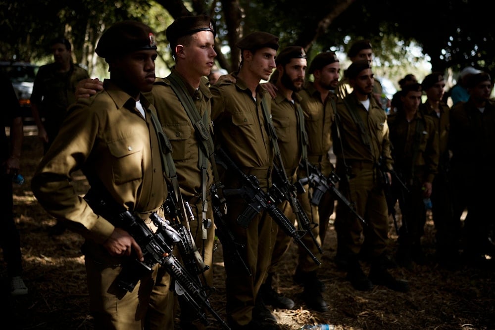 Israeli soldiers mourn Sgt. Amitai Alon, killed Sunday by a Hezbollah drone attack that wounded dozens and killed four soldiers, during his funeral near Ramot Naftali, 'Israel', on October 14, 2024. (AP)