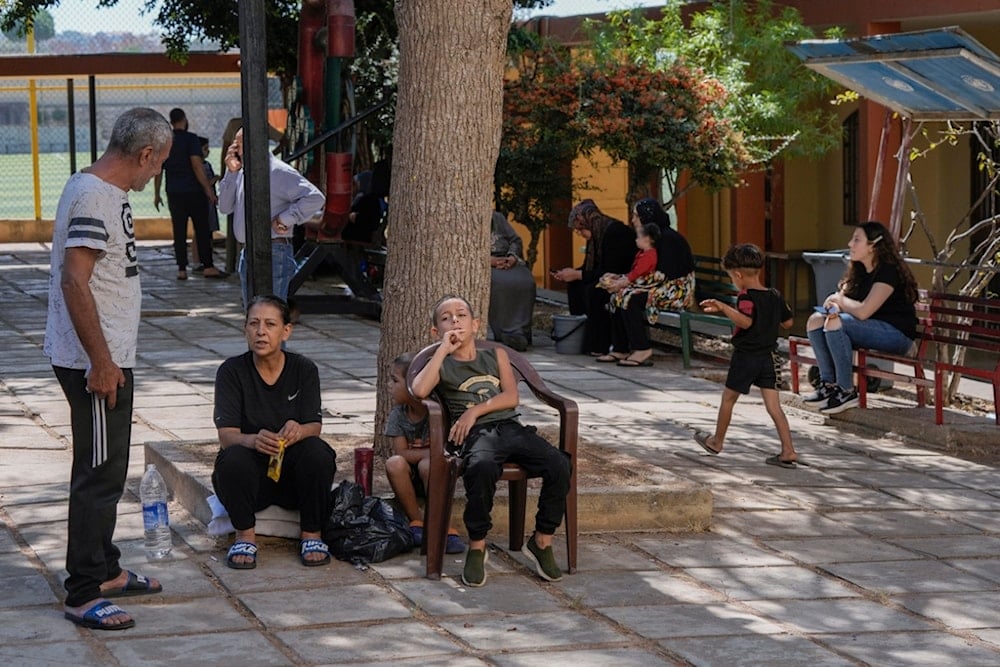 Displaced people sit at a vocational training center run by the UN agency for Palestinian refugees, or UNRWA, in the town of Sebline, south of Beirut, Lebanon, Friday, October 4, 2024 (AP)