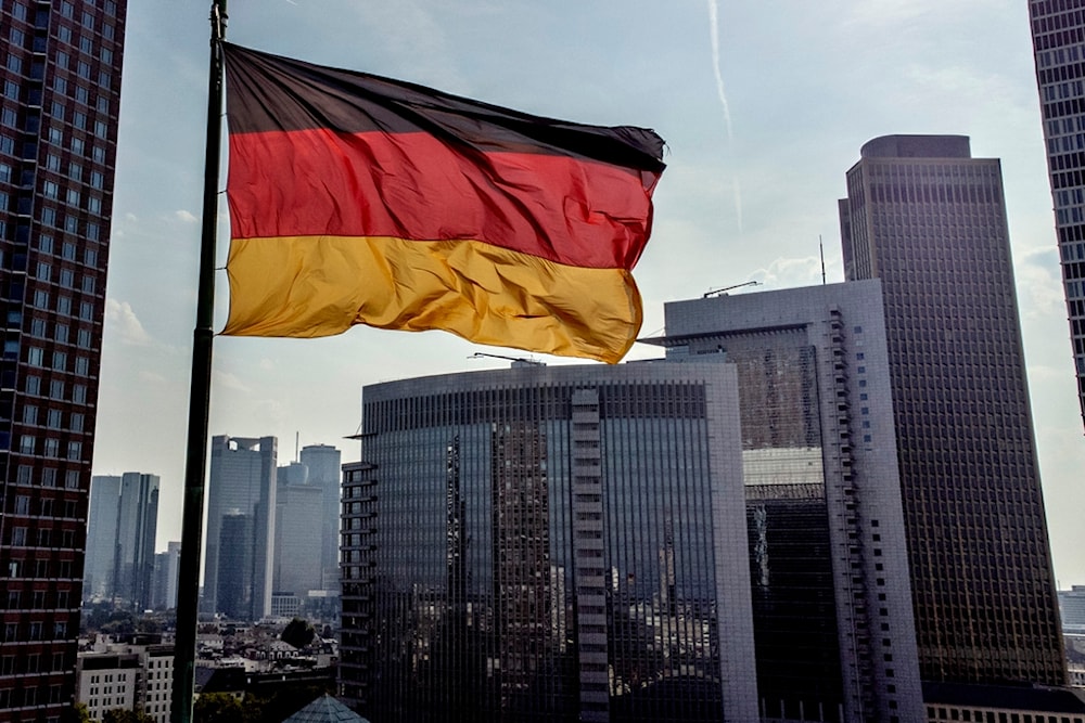 A German flag waves in front of the buildings of the banking district in Frankfurt, Germany, Friday, Aug. 30, 2024. (AP Photo/Michael Probst)