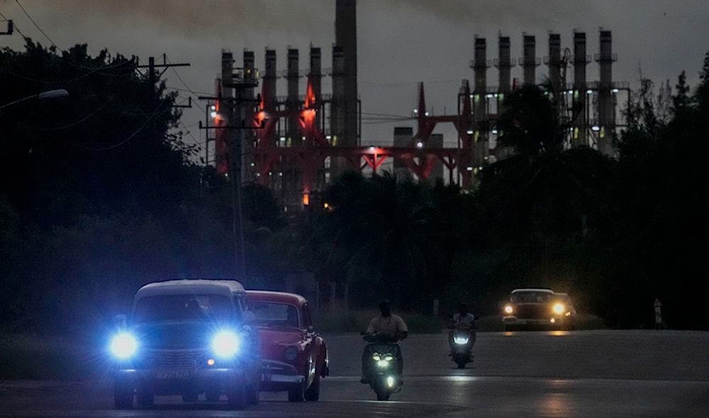 People drive their vehicles past a floating generator in operation, in Havana, Cuba, Tuesday, Oct. 22, 2024. (AP)