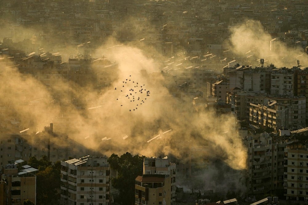 A flock of birds flies as smoke rises from the site of an Israeli airstrike in Dahiyeh, in the southern suburb of Beirut, Lebanon, Thursday, October 24, 2024 (AP)