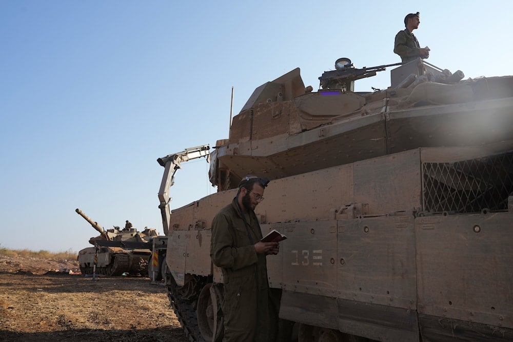 Israeli soldiers at a staging area in northern occupied Palestine on October 6, 2024. (AP)