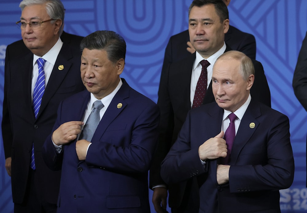 Chinese President Xi Jinping, left, and Russian President Vladimir Putin attend a family photo ceremony prior to Outreach/BRICS Plus format session at the BRICS Summit in Kazan, Russia, on October 24, 2024. (AP)