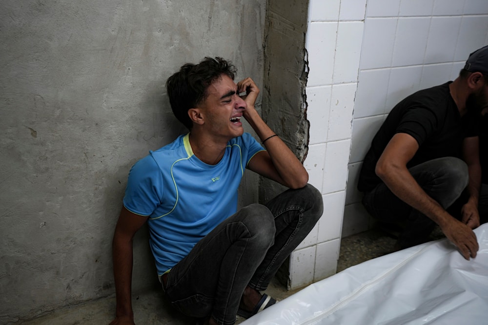 A young Palestinian mourns his relatives killed in the Israeli bombardment of the Gaza Strip at a hospital in Deir el-Balah, on October 20, 2024. (AP)