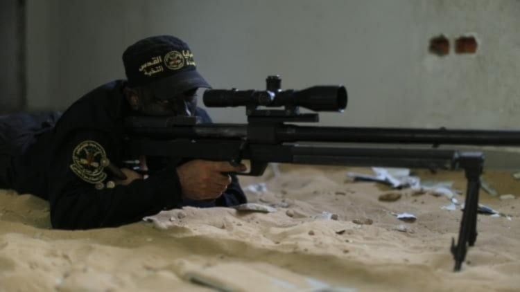 An al-Quds Brigades fighter prepares to snipe an Israeli soldier in Jabalia, northern Gaza in an undated photo (Military media)