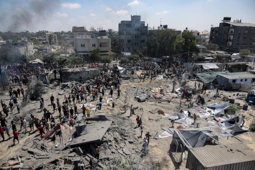 Palestinians inspect the damage at a site hit by an Israeli bombardment on Khan Younis, southern Gaza Strip, July 13, 2024. (AP)