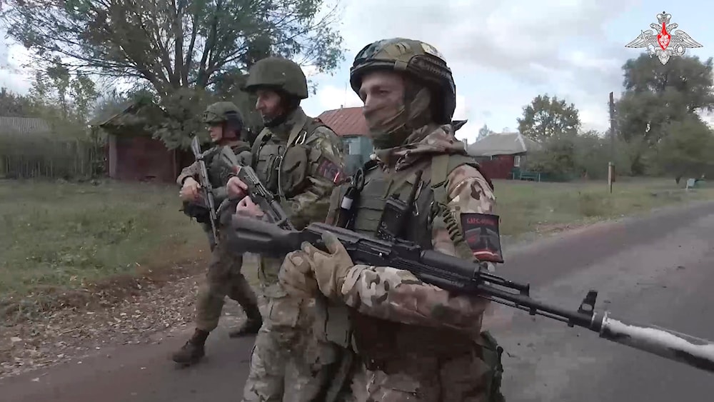 In this photo taken from video released by the Russian Defense Ministry on Thursday, Oct. 24, 2024, Russian soldiers patrol a village in the Russian - Ukrainian border area in the Kursk region, Russia. (AP)